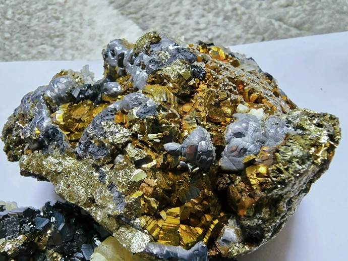 Golden metallic mineral cluster with grey accents